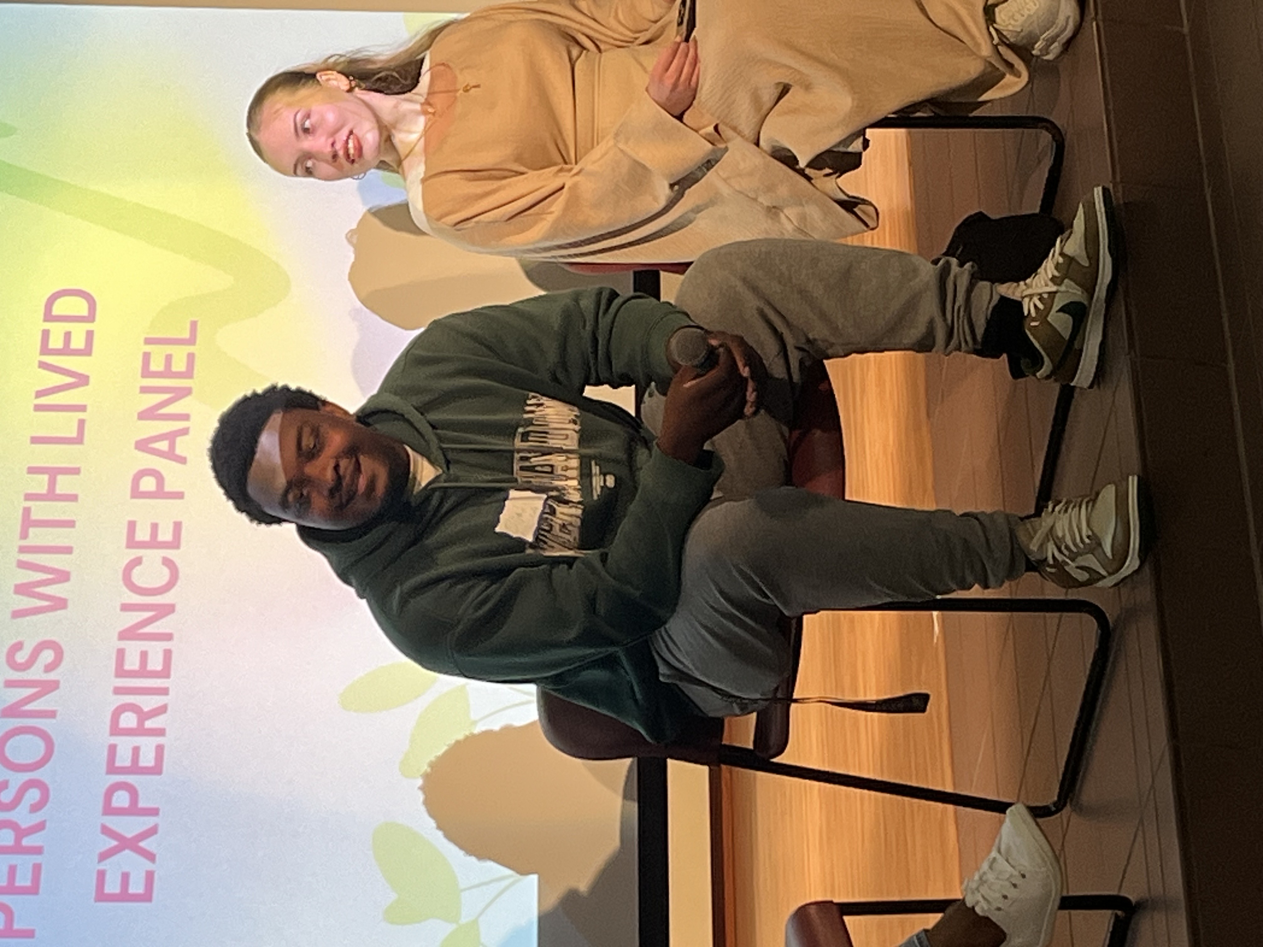 Panelists sharing lived experience perspectives at a community forum